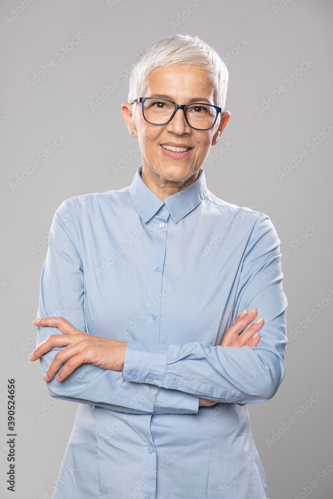 Senior businesswoman with glasses in a blue shirt and short white hair and glasses Senior businesswoman with glasses in a blue shirt and short white hair and glasses