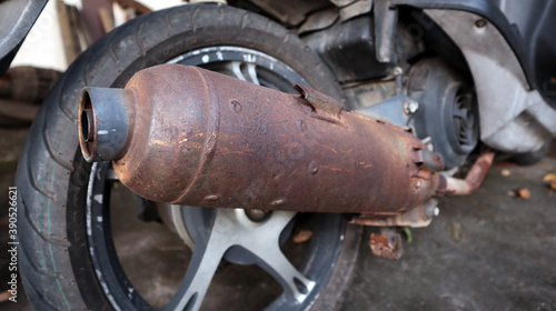 Rusted exhaust with motorecycle.