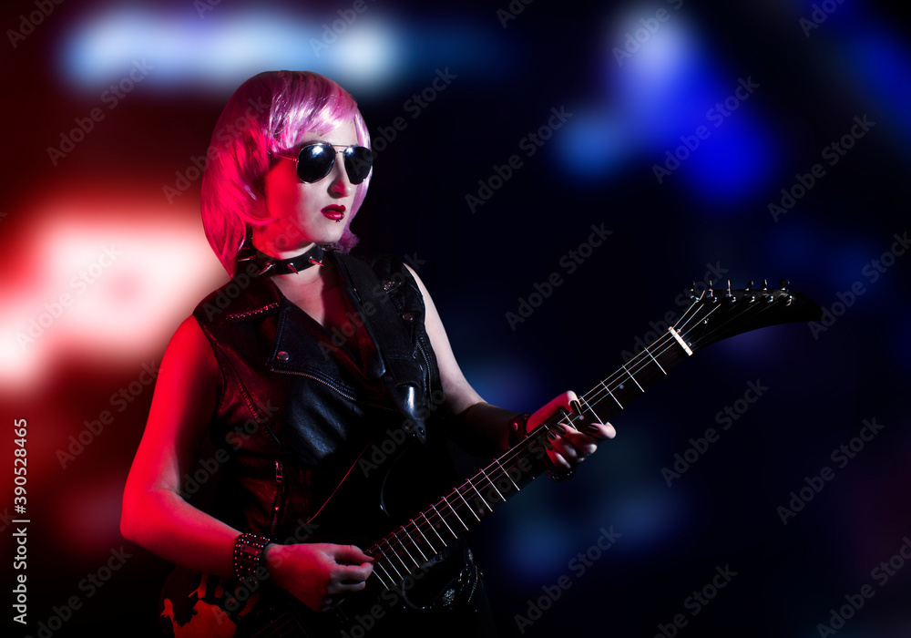 Young attractive pink haired rocker woman playing the electric guitar