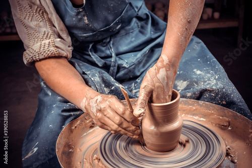 Artisan sculptor works with clay on a Potter's wheel and at the table with the tools. Ceramics art concept. Close-up.