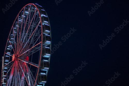 Ferris wheel on dark sky background.