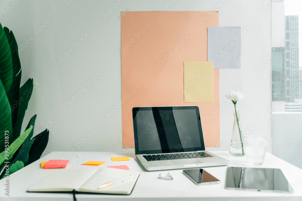 Naklejka premium Minimal office desk with blank space laptop computer and digital gadget.
