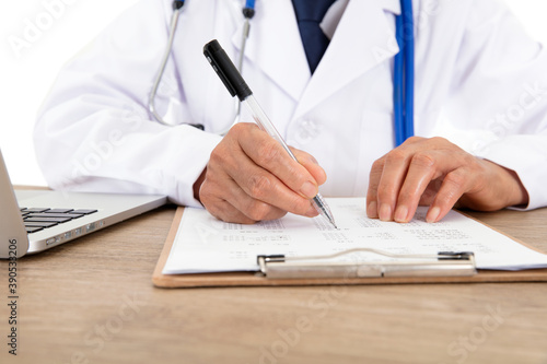Doctors in white coats are signing relevant documents