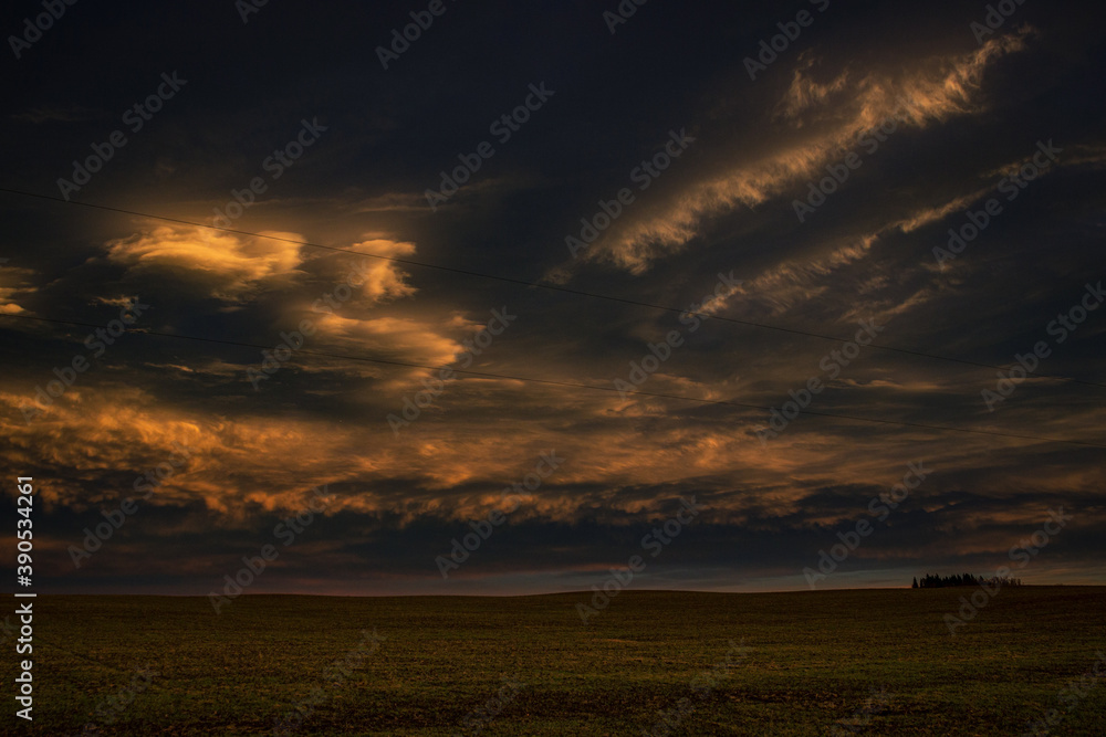 stormy sunset over field 