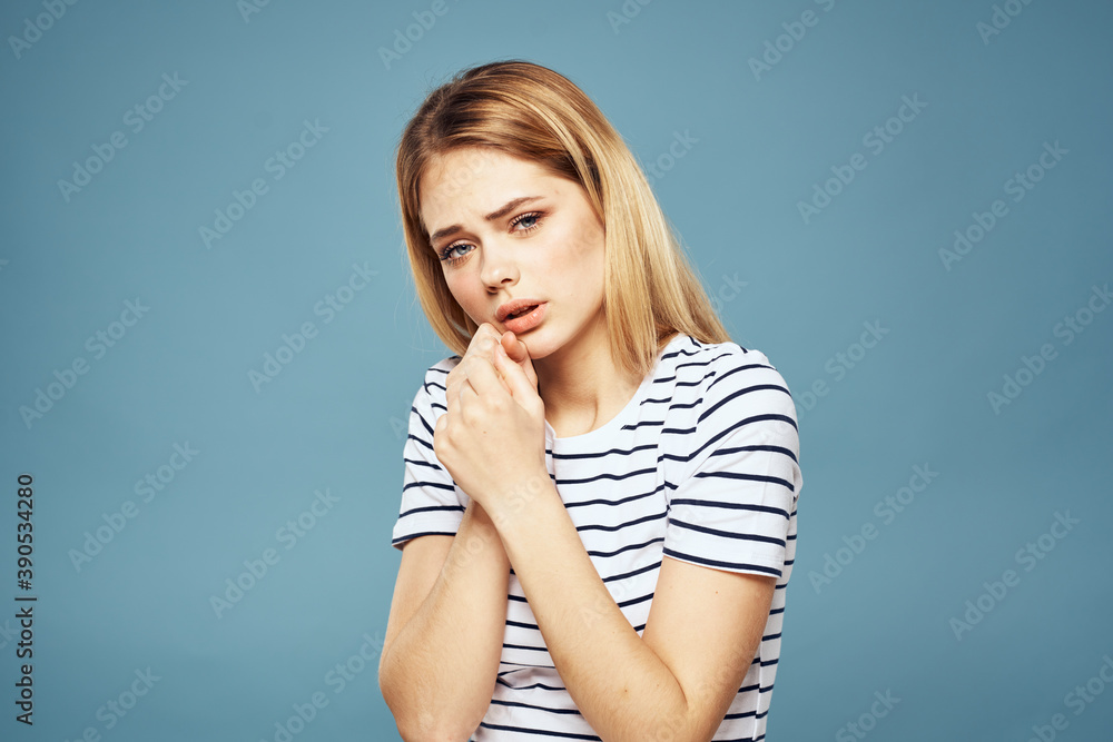 woman wearing striped t-shirt cropped view blue isolated background displeased facial expression woman wearing striped t-shirt cropped view blue isolated background displeased facial expression