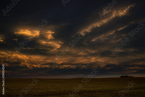 stormy sunset over field 