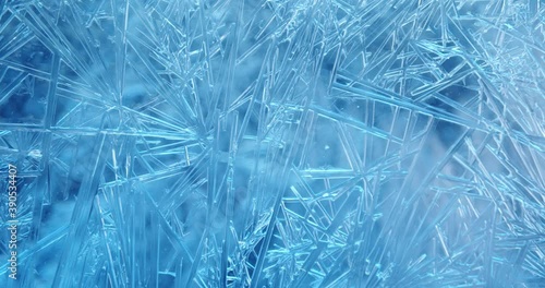 Frost covered window with lights shimmering and glittering over ice crystals. Seamless Loop.