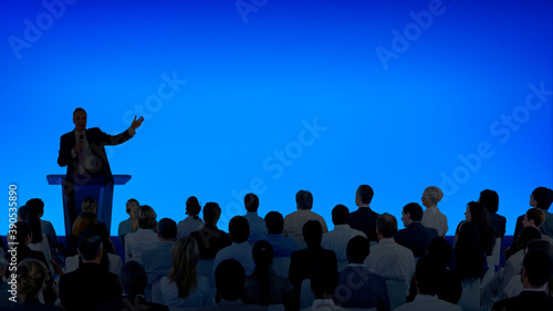 Fotografering Corporate businessman giving a presentation to a large audience
