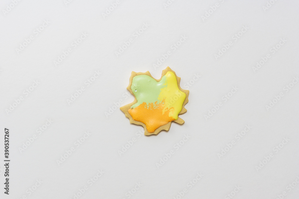 Sweet homemade leaf cookie with icing isolated on white background minimal flat lay composition. Sweet homemade leaf cookie with icing isolated on white background minimal flat lay composition.