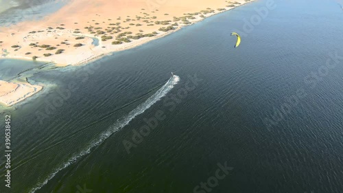 drone shoot of a kite surfer surfing on the creek