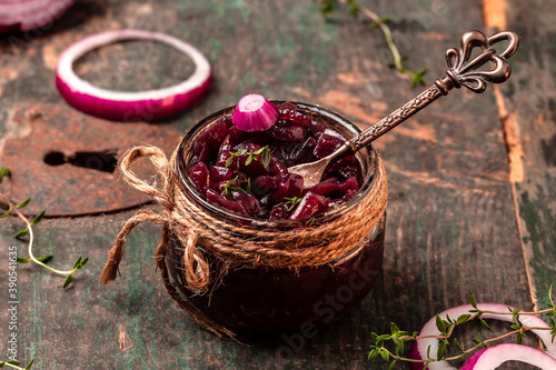 Onion jam marmalade jam, confiture, chutney on wooden table, with wine and thyme, banner, menu, recipe, place for text