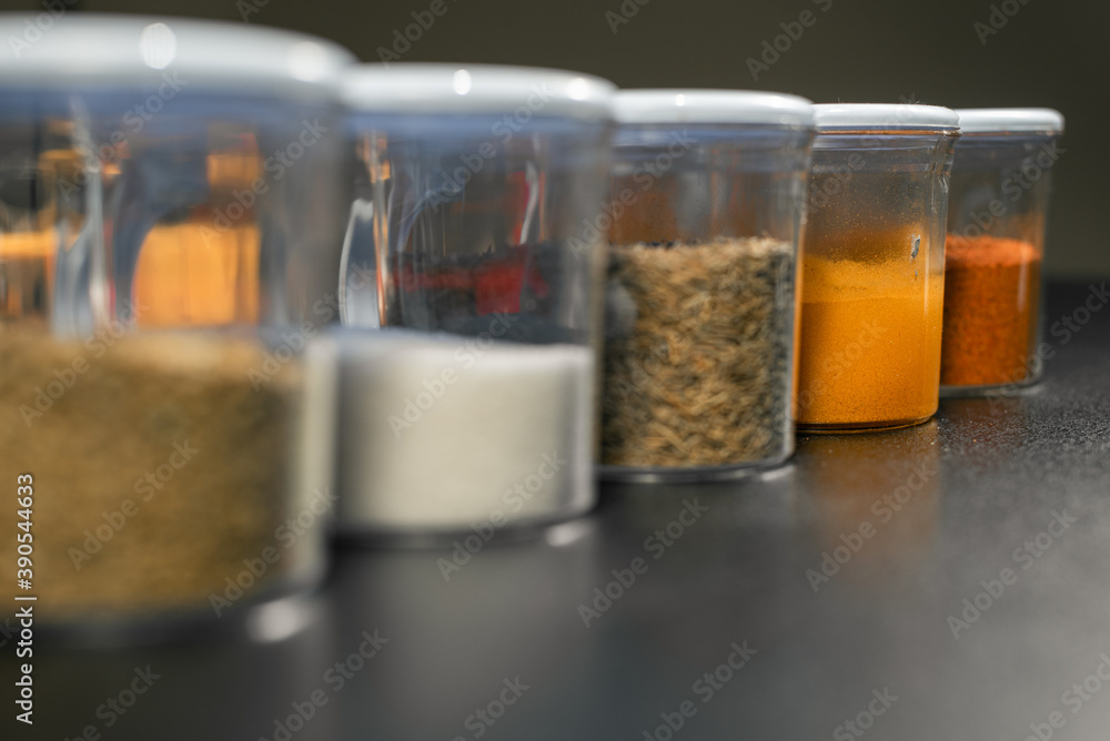 Turmeric in focus in random spice jars