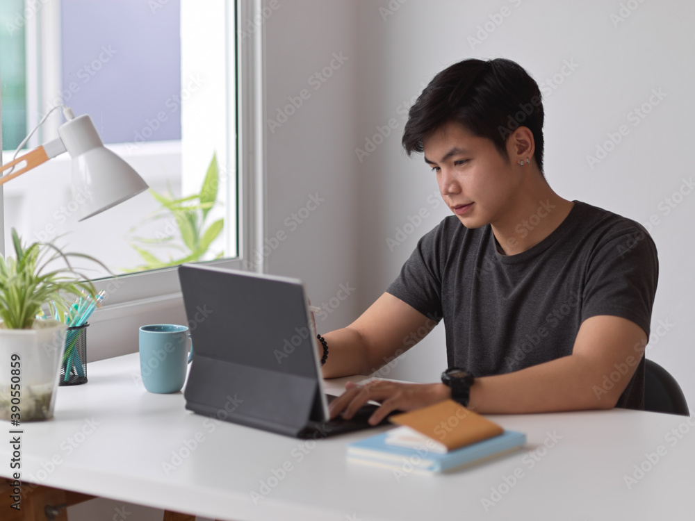 Portrait of male working with digital tablet and stationery in home office Portrait of male working with digital tablet and stationery in home office