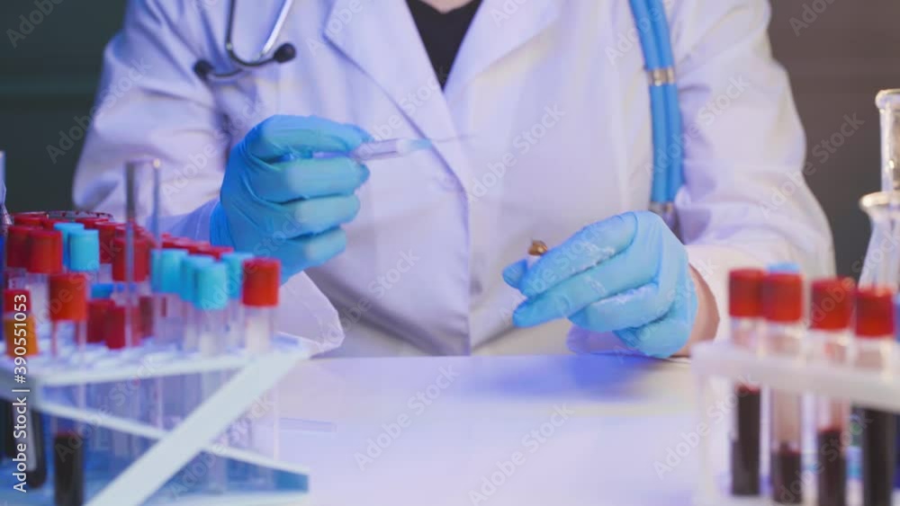 Female doctor or nurse preparing injection syringe filling with ampoule liquid in clinic Female doctor or nurse preparing injection syringe filling with ampoule liquid in clinic