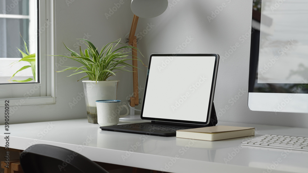Home office with digital tablet, keyboard, computer and decorations Home office with digital tablet, keyboard, computer and decorations