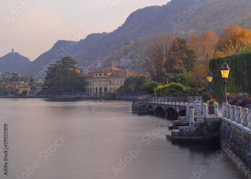 Wallpaper Mural Suggestive pedestrian path runs along the lake at sunset.Autumn landscape on Como lake, Lombardy, Italy. Torontodigital.ca