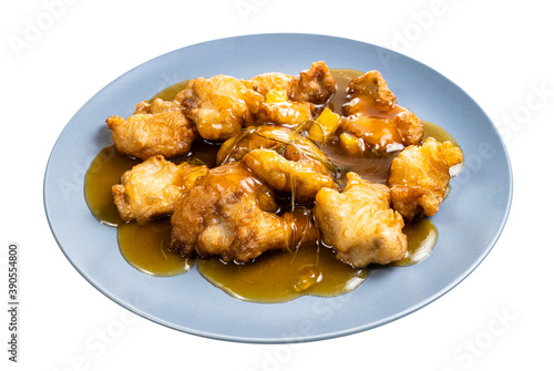 chinese cuisine - Pork in orange sauce (sliced pork tenderloin fried in batter with orange sauce and garnished with cilantro) on blue plate isolated on white background