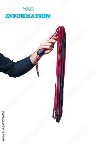 Leather whip in male hand isolated on white background. Strict black and red whip in man's hand. Accessories for adult sexual games. Toys for BDSM, flogging, sexual fetish and spanking devices.