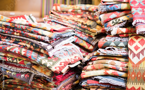 Stack of traditional colorful carpets in carpet shop, nobody © JackF