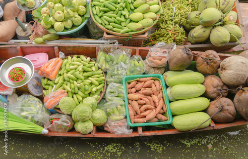 Damnoen Saduak Floating Market or Amphawa. Local people sell fruits, traditional food on boats in canal, Ratchaburi District, Thailand. Famous Asian tourist attraction. photo