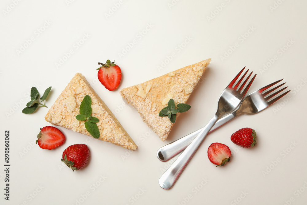 Pieces of Napoleon cake, strawberry and forks on white background Pieces of Napoleon cake, strawberry and forks on white background