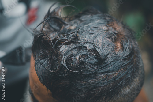 Old man dyes his hair in home. Black color hair