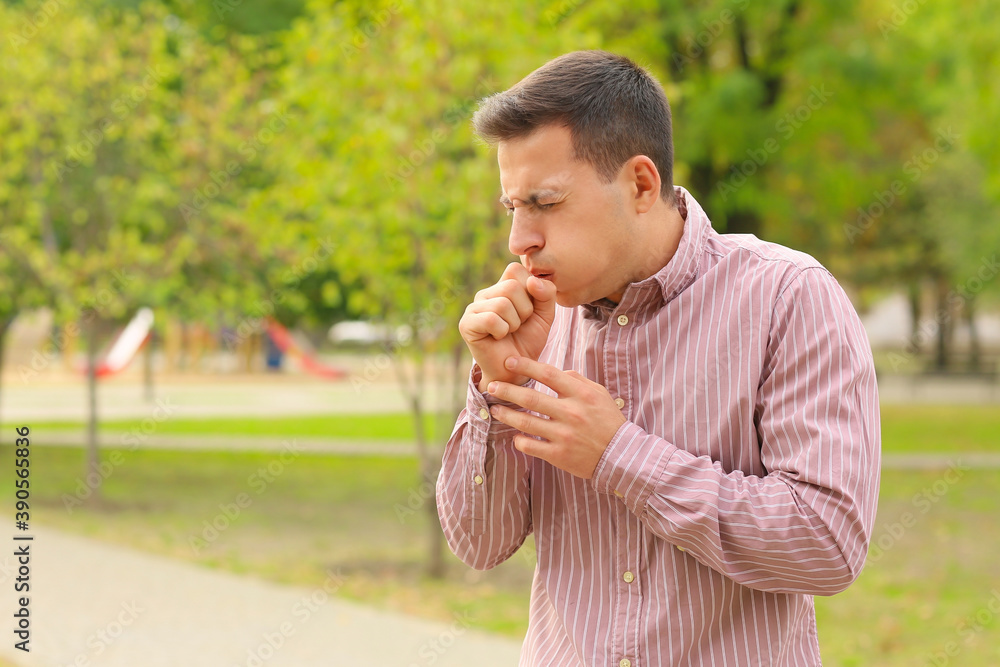 Fototapeta premium Young man suffering from allergy outdoors
