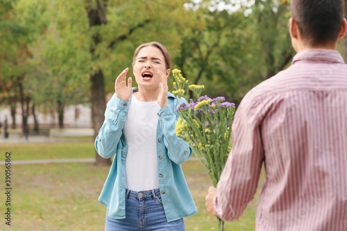 Man giving flowers to his a...