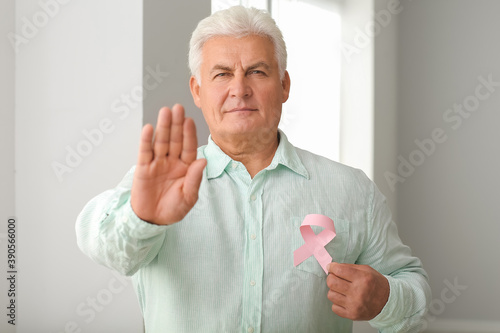 Mature man with pink ribbon...