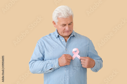Mature man with pink ribbon...