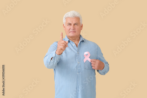 Mature man with pink ribbon...