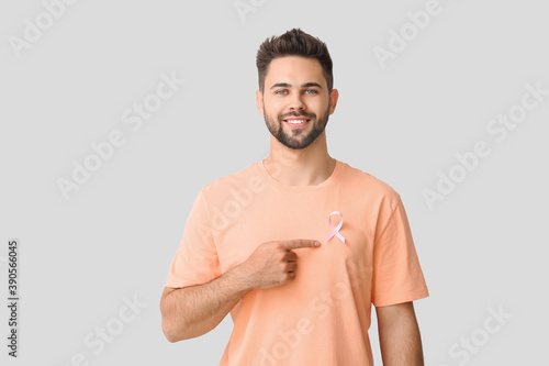 Man with pink ribbon on lig...