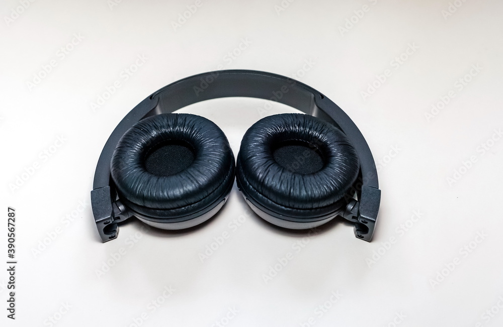 Black wireless headphones for audio electronic devices close up on white background