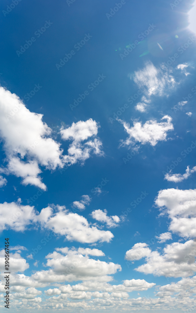 Fototapeta premium Fantastic clouds against blue sky, vertical panorama