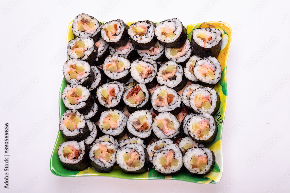 Top view of stack of Japanese sushi maki roll plate. Served in Japanese bar restaurant with chopstick Top view of stack of Japanese sushi maki roll plate. Served in Japanese bar restaurant with chopstick