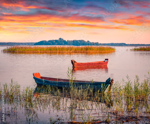 Two fifhing boats on the Svityaz lake. Spectacular sunrise on Shatsky National Park, Volyn region, Ukraine, Europe. Beauty of nature concept background.. photo