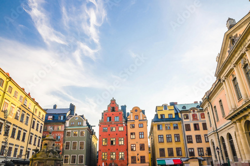 Watercolor drawing of Traditional buildings with colorful walls, Nobel Museum and fountain on Stortorget square in old historical town quarter Gamla Stan of Stadsholmen island, Stockholm, Sweden
