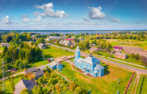 Aerial summer view from flying drone of Krymne village with St. Michael Church, Volyn region, Ukraine, Europe. Attractive morning scene of Domashnje lake.