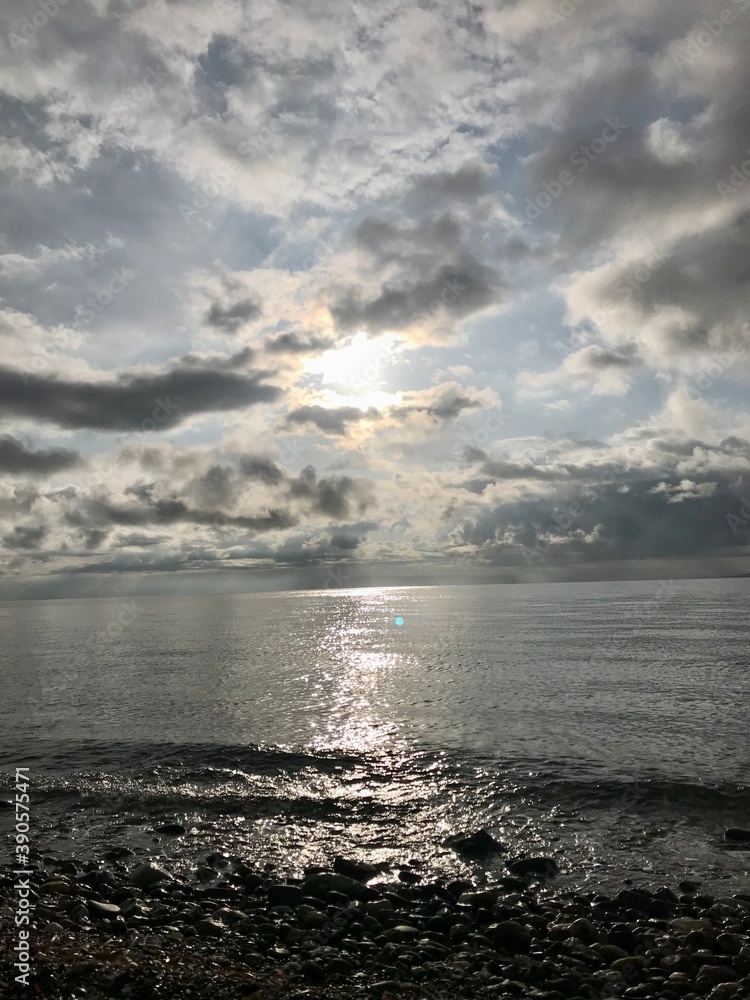 Beautiful peaceful bay view, reflection on the sea and cloudy sky at sunset at Mediterranean, Aegean sea. Sunset at the horizon. Beautiful peaceful bay view, reflection on the sea and cloudy sky at sunset at Mediterranean, Aegean sea. Sunset at the horizon.