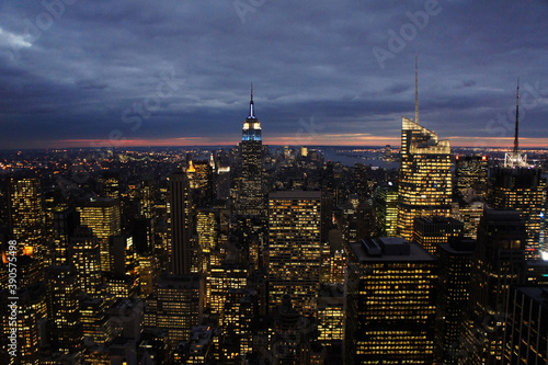 New york city lights of business offices in Manhattan at dusk or dawn. Urban cityscape at twilight. Concept of overpopulated megapolis. USA/America. Home office concept during coronavirus. 
