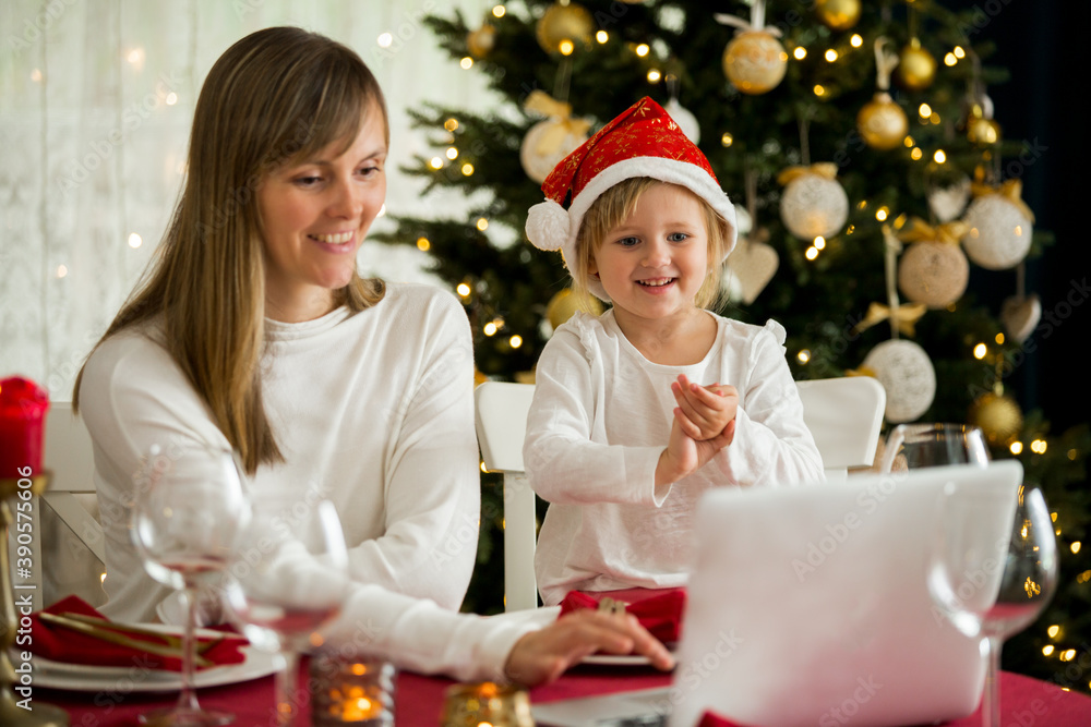 A happy family with a child is celebrating Christmas with their friends on video call using webcam. Family greeting their relatives on Christmas eve online. New normal
virtual event A happy family with a child is celebrating Christmas with their friends on video call using webcam. Family greeting their relatives on Christmas eve online. New normal
virtual event