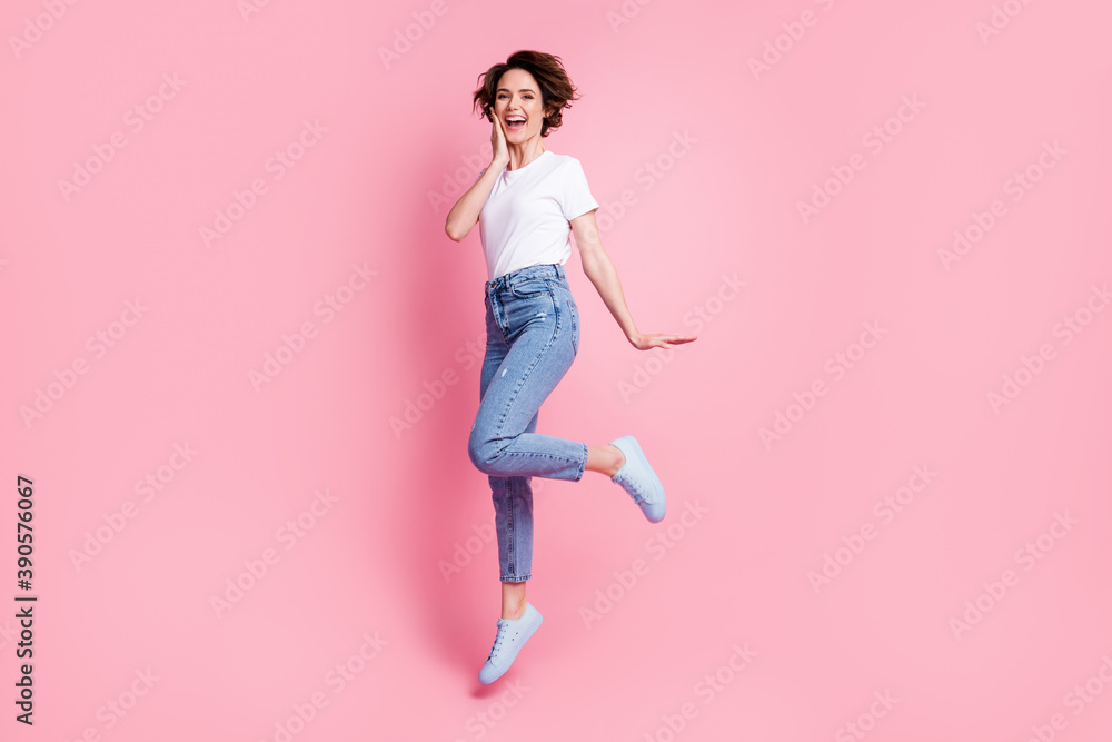 Full length body size view of attractive cheerful cheery brown-haired girl jumping having fun isolated over pink color background