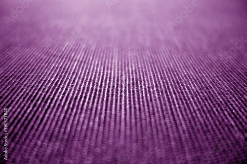 Textile pattern close-up with blur defocused effect in violet color.