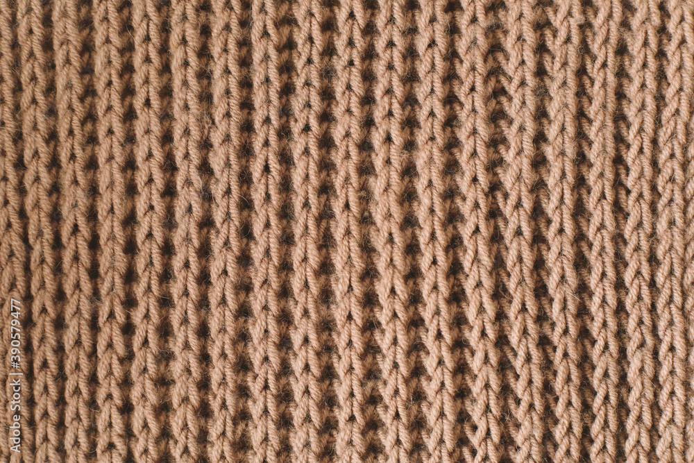 Knitting pattern of wool. Knitting. Texture of knitted woolen fabric for wallpaper and an abstract background Knitting pattern of wool. Knitting. Texture of knitted woolen fabric for wallpaper and an abstract background