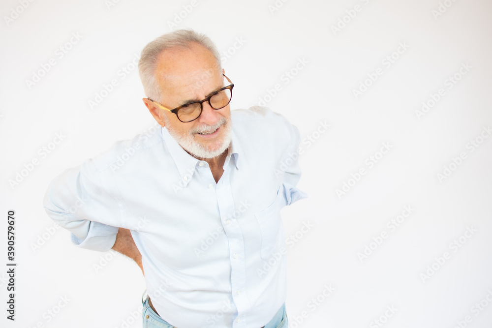 Portrait and close up image of a senior man having a hip pain against white background Portrait and close up image of a senior man having a hip pain against white background