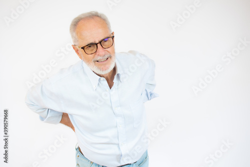 Portrait and close up image of a senior man having a hip pain against white background