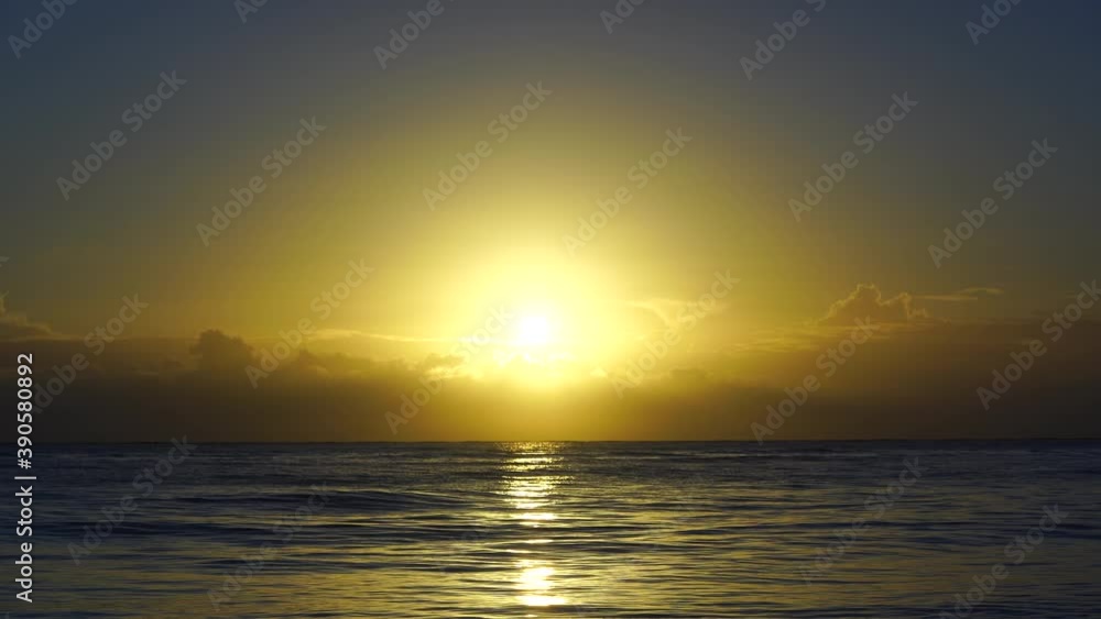 A magnificent sunrise over the Indian Ocean on the island of Zanzibar, Tanzania, east Africa. Travel and nature concept. Sun, blue sky and sea water A magnificent sunrise over the Indian Ocean on the island of Zanzibar, Tanzania, east Africa. Travel and nature concept. Sun, blue sky and sea water