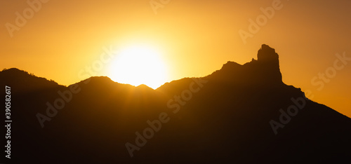 Panoramic view of Roque Nublo mountain silhouette at sunset in Canary Islands. Fabulous natural landscape at twilight in Gran Canaria  Spain. Travel attraction  tourist destination concepts