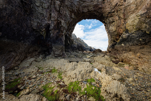 Sea arch at Pointe de Dinan on a cloudy day in summer © Stefan