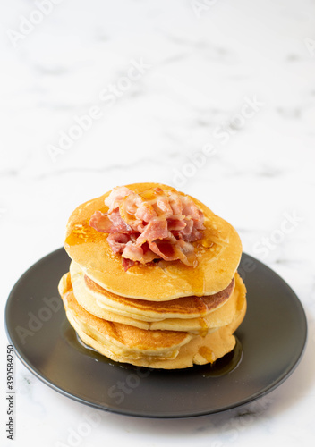 A fresh made pancake with crispy bacon and syrup, traditionale Dutch recipe photo